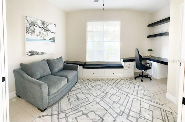 tiled home office featuring ceiling fan