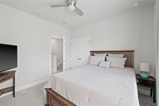 bedroom with a closet, visible vents, and carpet