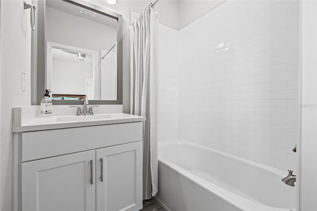 full bath featuring shower / bath combo with shower curtain, vanity, and visible vents