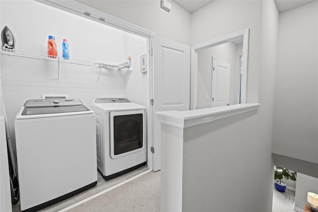 clothes washing area featuring independent washer and dryer and laundry area