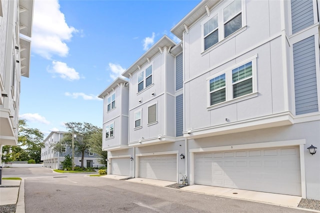 exterior space featuring a residential view and an attached garage