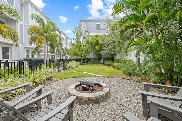 view of yard featuring a fenced backyard and a fire pit