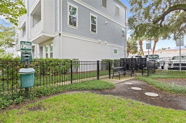 view of side of home with fence and mail area