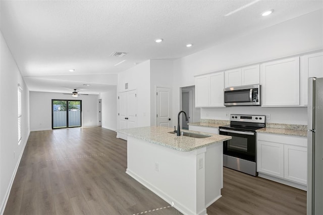 kitchen with sink, light stone countertops, ceiling fan, appliances with stainless steel finishes, and white cabinets