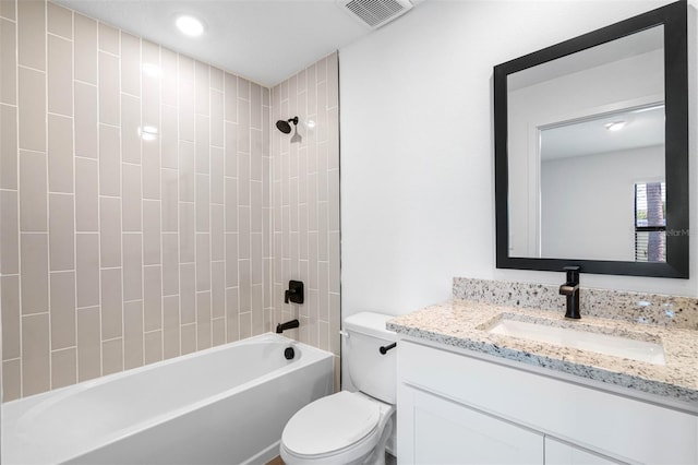 full bathroom featuring tiled shower / bath combo, vanity, and toilet