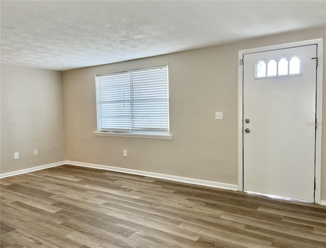 foyer featuring a textured ceiling and hardwood / wood-style flooring