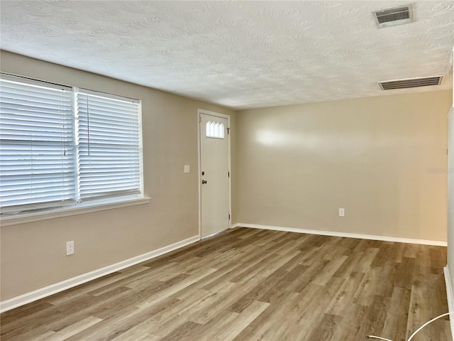 entrance foyer featuring hardwood / wood-style flooring and a textured ceiling