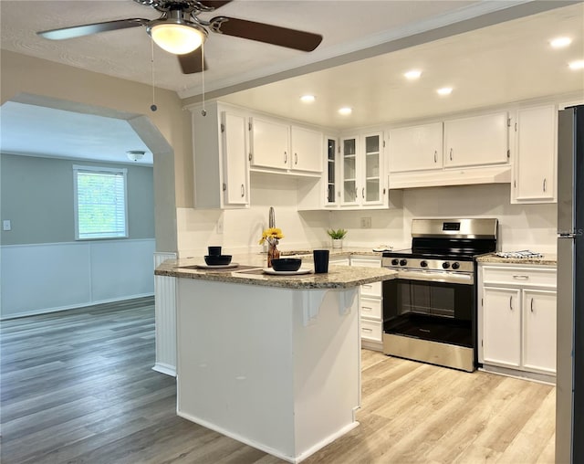 kitchen featuring white cabinetry, light stone counters, stainless steel appliances, and ceiling fan