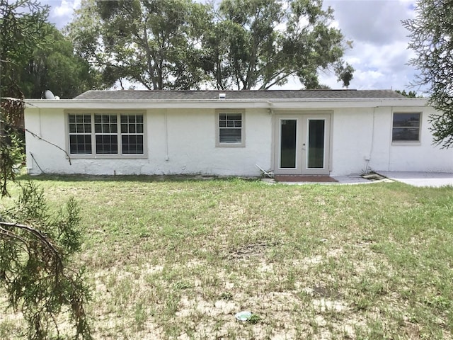 view of front facade featuring a front lawn and french doors