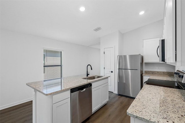 kitchen featuring dark hardwood / wood-style floors, an island with sink, stainless steel appliances, sink, and white cabinets