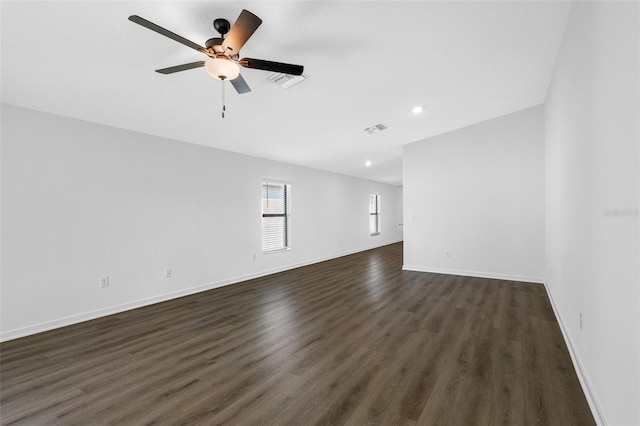 unfurnished room featuring dark wood-type flooring and ceiling fan