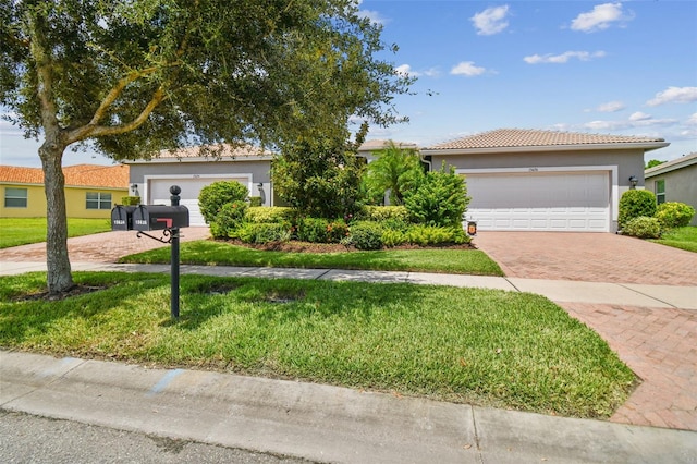 view of front of property featuring a garage and a front lawn