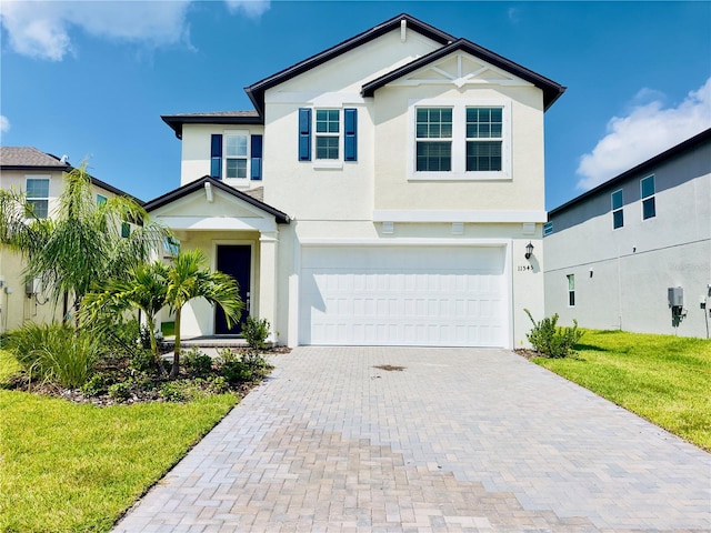 view of front facade with a garage and a front lawn