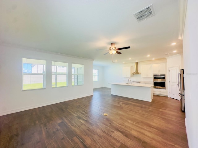 unfurnished living room with ornamental molding, ceiling fan, dark hardwood / wood-style floors, and sink