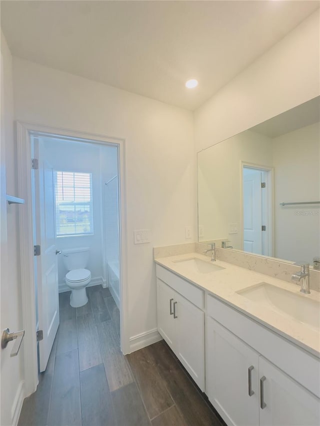 bathroom with vanity, hardwood / wood-style floors, and toilet