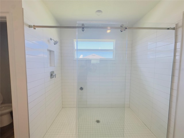 bathroom with toilet and a shower with shower door