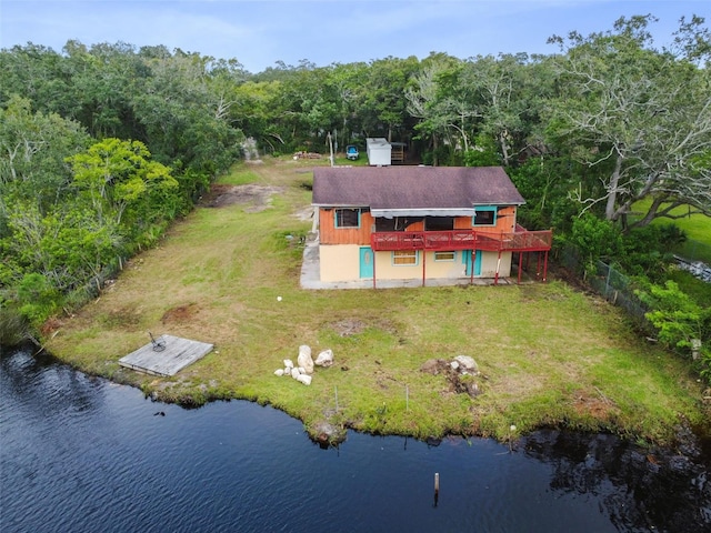 aerial view featuring a view of trees and a water view