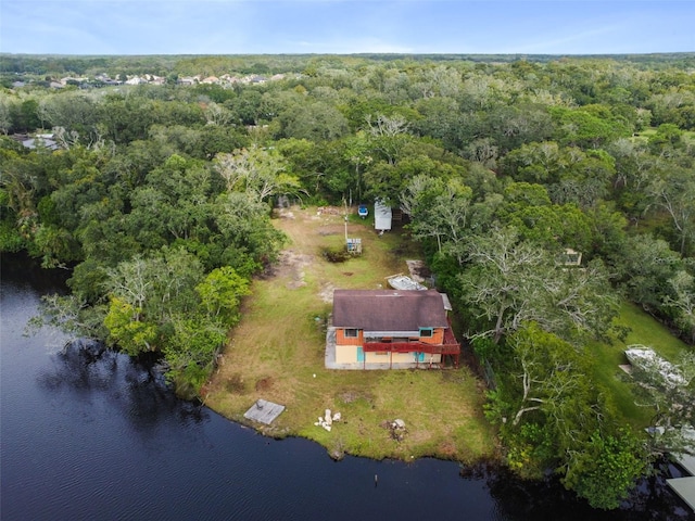 aerial view with a forest view and a water view