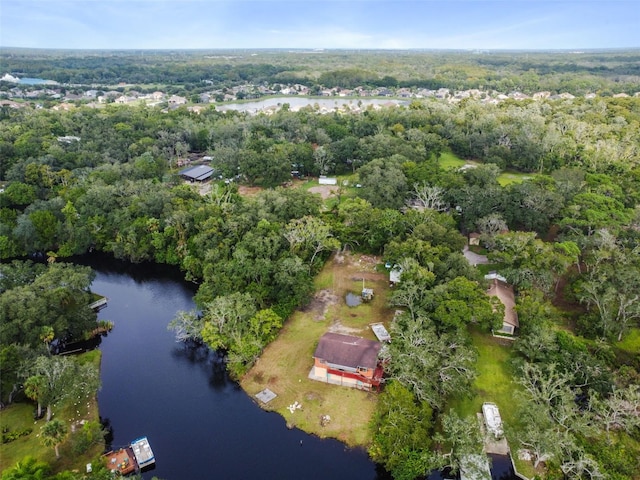 birds eye view of property with a water view and a view of trees