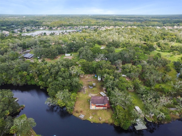 aerial view featuring a wooded view and a water view