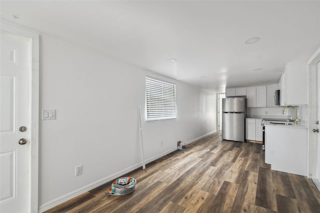 kitchen featuring dark hardwood / wood-style flooring, stainless steel appliances, and sink