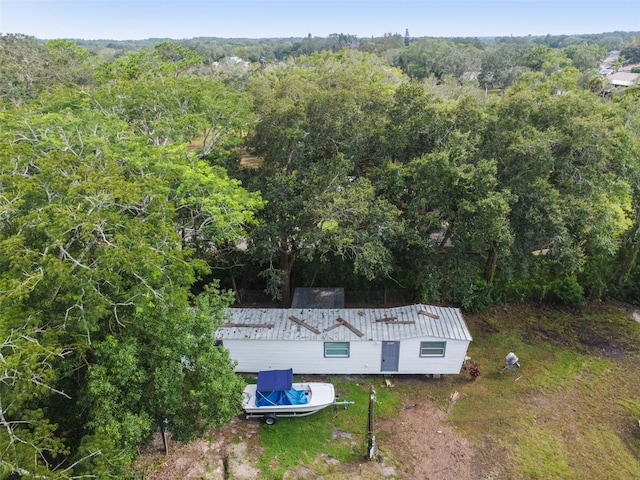 drone / aerial view featuring a wooded view