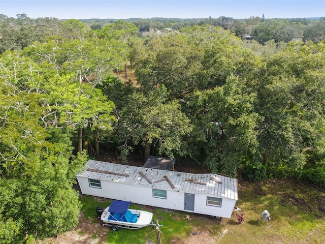 drone / aerial view with a wooded view