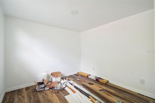 empty room with dark hardwood / wood-style flooring