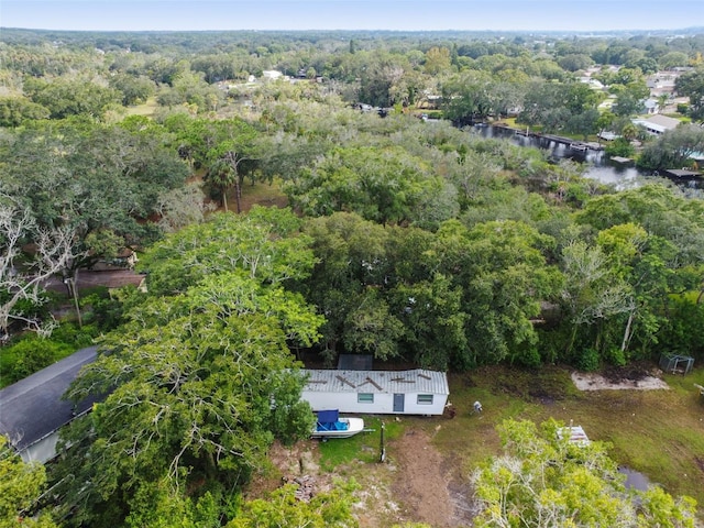 birds eye view of property with a forest view and a water view