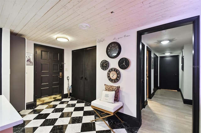 mudroom featuring wood ceiling and light hardwood / wood-style flooring