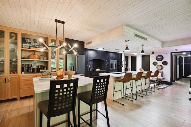 dining area featuring wood ceiling, light hardwood / wood-style floors, and sink