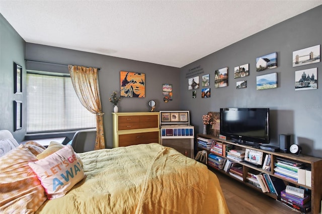 bedroom with dark wood-type flooring and a textured ceiling