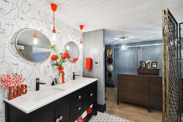 bathroom featuring vanity, wood-type flooring, and a notable chandelier