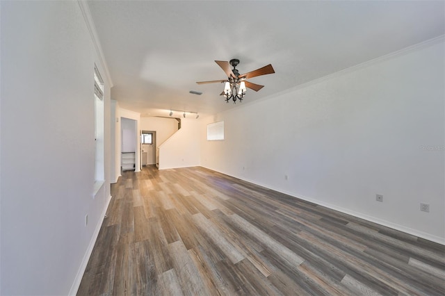 unfurnished living room featuring ceiling fan, crown molding, and wood-type flooring