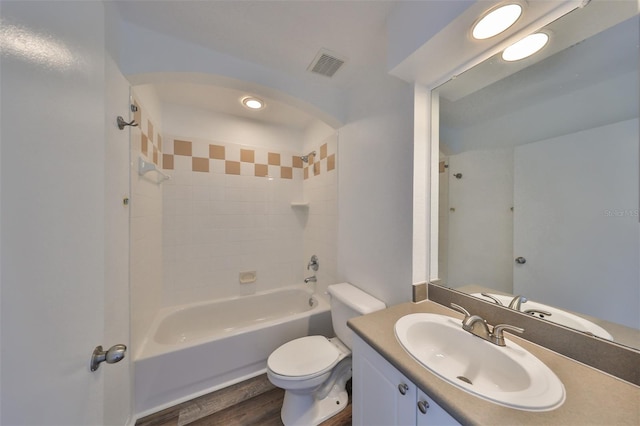 full bathroom with toilet, hardwood / wood-style flooring, shower / bath combination, and vanity