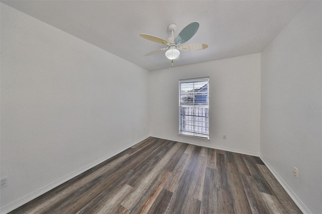 empty room with ceiling fan and dark hardwood / wood-style floors