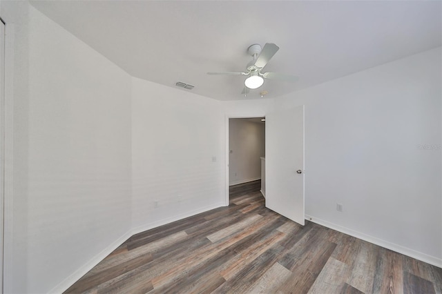 spare room with ceiling fan and dark hardwood / wood-style floors