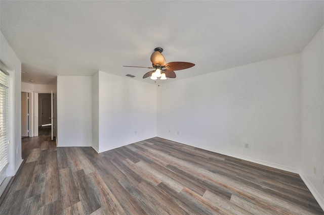 empty room with ceiling fan and dark hardwood / wood-style floors