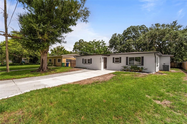 ranch-style home with a front yard and central AC unit