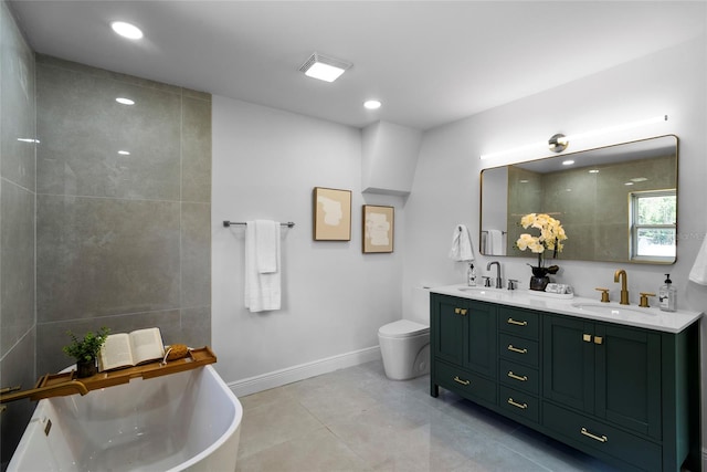 bathroom with tile patterned flooring, a tub to relax in, toilet, and vanity