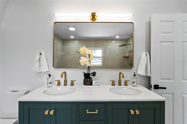 bathroom featuring a tile shower and vanity