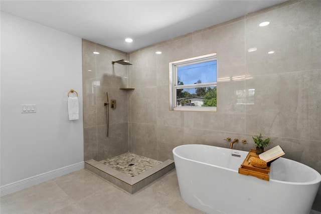 bathroom with tile walls, separate shower and tub, and tile patterned floors