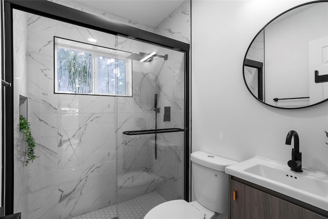 bathroom featuring vanity, toilet, and an enclosed shower