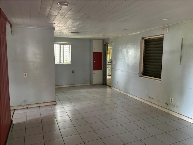 tiled spare room with ornamental molding and wooden ceiling