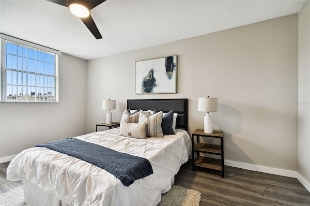 bedroom featuring a textured ceiling, ceiling fan, and dark hardwood / wood-style floors