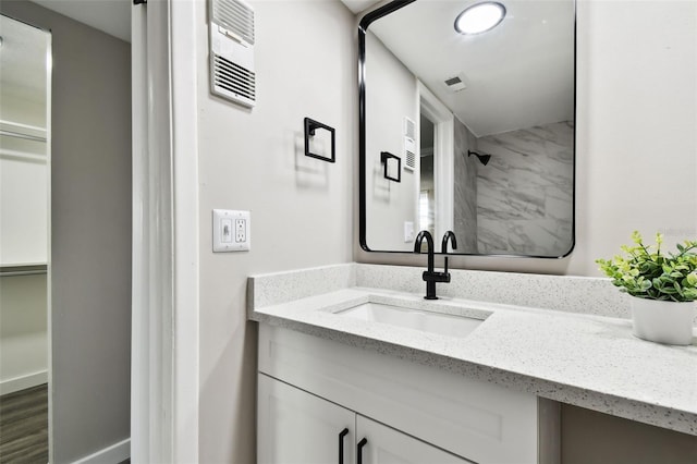 5095 Bay St NE Unit 306, Saint Petersburg, FL 33703 - bathroom featuring walk in shower, visible vents, and vanity