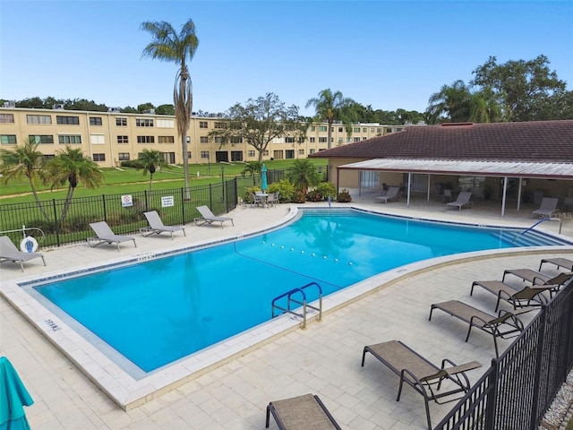5095 Bay St NE Unit 306, Saint Petersburg, FL 33703 - pool with a patio area and fence