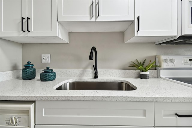 kitchen featuring light stone countertops, white range, white cabinetry, and sink