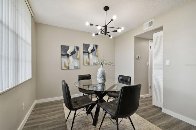 5095 Bay St NE Unit 306, Saint Petersburg, FL 33703 - dining area with baseboards, a notable chandelier, dark wood-style floors, and visible vents