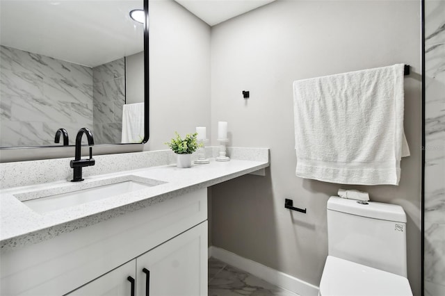 5095 Bay St NE Unit 306, Saint Petersburg, FL 33703 - bathroom featuring vanity, toilet, marble finish floor, and baseboards